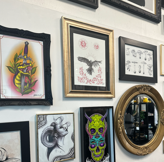 framed art on tattoo studio wall