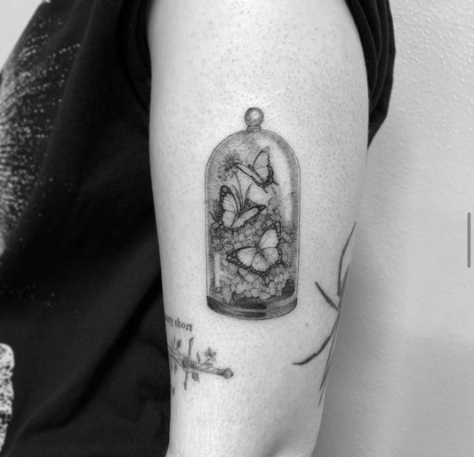 micro realism tattoo on womans arm